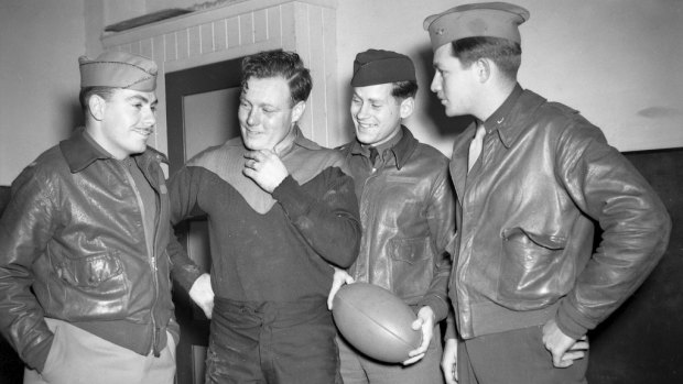 War stories: Three US airmen interested in Australian Rules football are photographed with Squadron Leader and Melbourne Football Club 
champion Keith Truscott in 1942.