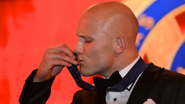Gary Ablett kisses the 2013 Brownlow Medal.
