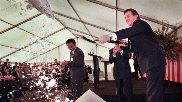 Then premier Jeff Kennett shovels sand at the waiting media as he launches the start of construction on CityLink in 1996.