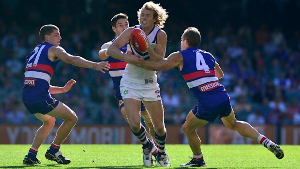 David Mundy breaks through three Bulldogs opponents in an earlier clash with the club.