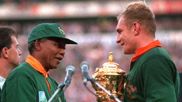 South African president Nelson Mandela hands over the Webb Ellis Cup to Springboks captain Francois Pienaar in 1995. 