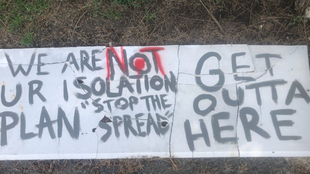 "Go away" signs have appeared along the road into Berrara, NSW.