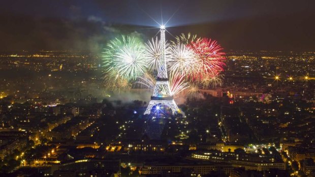 The Eiffel Tower is illuminated during the traditional Bastille Day fireworks display in Paris.