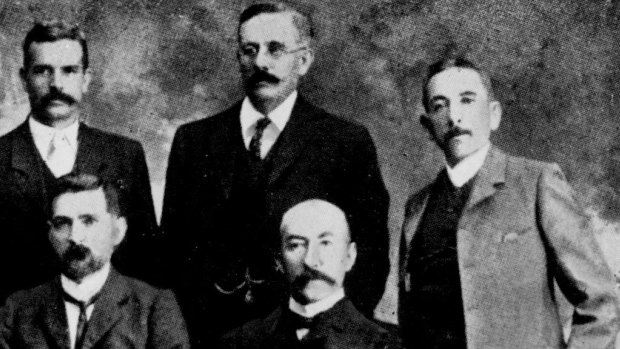 Billy Hughes, far right, and Hugh Mahon standing second from right in the first Commonwealth Labor ministry in 1904, in which Mahon was postmaster-general.