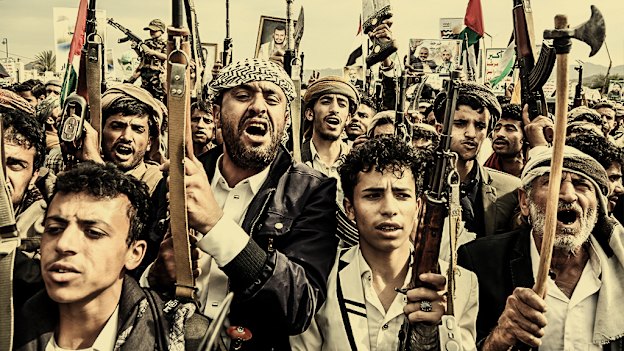 Yemenis with rifles and Houthi emblems show solidarity with Palestinian people on August 9 in the capital, Sanaa. 