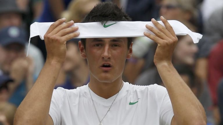 Bernard Tomic of Australia puts on his headband during his quarter-final match against Novak Djokovic of Serbia at the 2011 Wimbledon tennis championships.