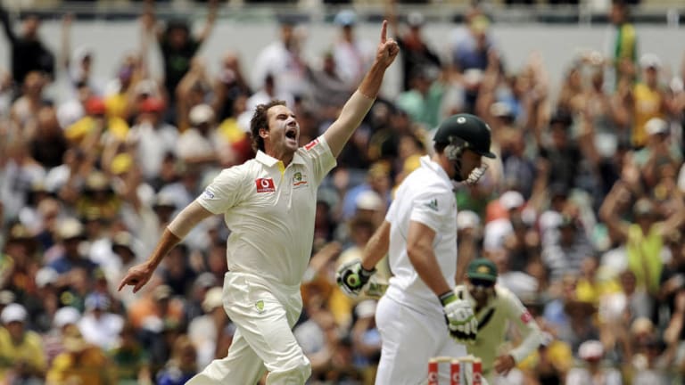 Bowler John hastings (L) celebrates after taking the wicket of South African batsman AB De Villiers.