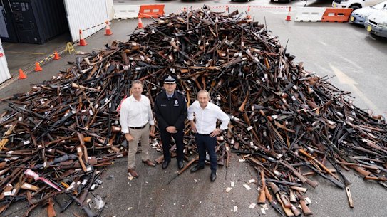 Western Australian Premier Roger Cook, former Western Australian Police Minister Paul Papalia and Police Commissioner Col Blanch with weapons collected during the buyback.