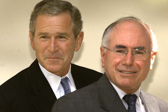 Then United States president George W.  Bush and then Australian prime minister John Howard walk together from the Oval Office of the White House following a meeting on September 10, 2001.