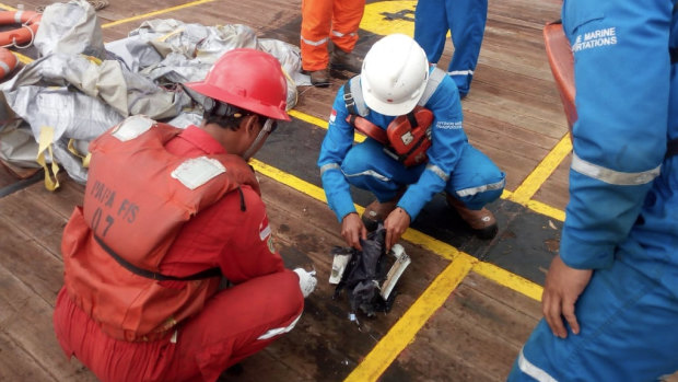 Recovery teams sift through debris believed to be from the crashed Lion Air flight. 