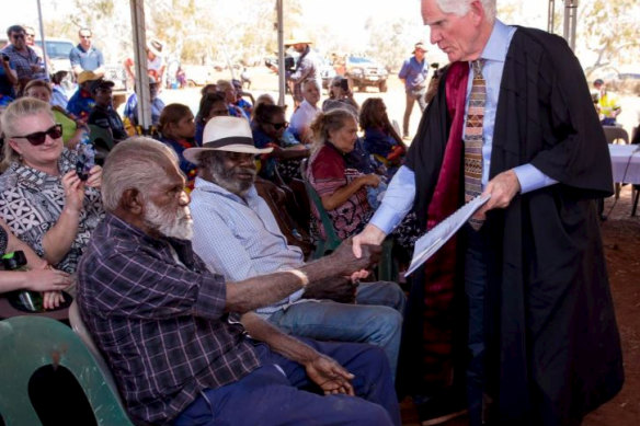 Federal Court Justice Michael Barker, right, shakes hands with David Stock after the Nyiyaparli won a native title claim over about 40,000 square kilometres of the Pilbara in 2018. 