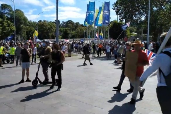 Anti-vaccine protesters chant ‘free Novak’ outside Rod Laver Arena.