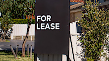 For lease sign on a blue display outside of a resedential building in Australia. Investment property real estate concept