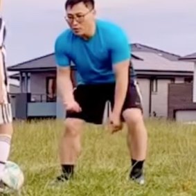 Kwang Kyung Yoo playing soccer with a child in 2022.