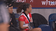 Nita Maynard-Perrin on the bench with her phone mid-game on Saturday.