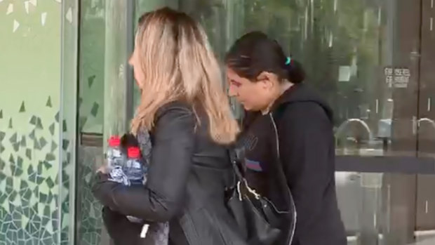 Camila Zeidan, right, leaves the inquest at Lidcombe Coroners Court on Monday.