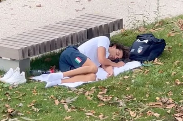 Italian swimming champion Thomas Ceccon takes a nap al fresco.