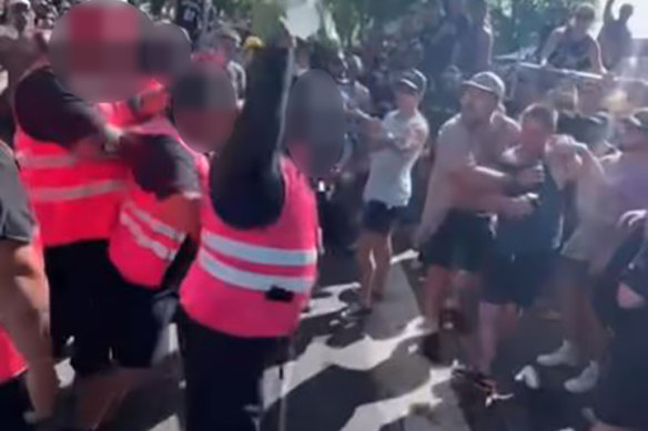 The crowd safety staff and spectators confronted each other before the fight broke out.