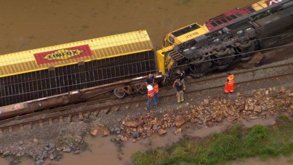 A train left the tracks, the driver escaping with minor injuries, in floodwater south of Gympie early on Wednesday.