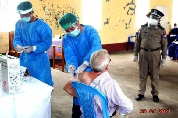 Turnell receives a shot of the vaccine at Insein Prison, according to a military-run newspaper.