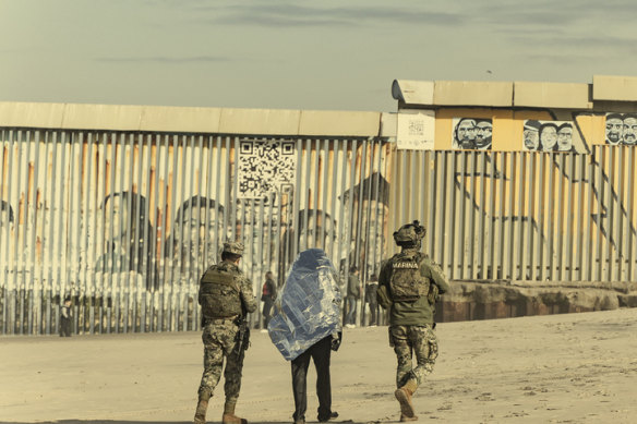 A man is detained during the deployment of National Guard troops at the US border in Tijuana, Mexico, on February 5. 