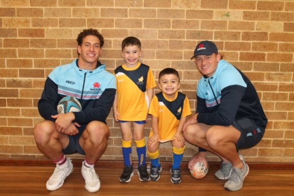 Waratahs players Mark Nawaqanitawase and Tane Edmed pay a visit to Dundas Valley Junior Rugby Union Club this week. 