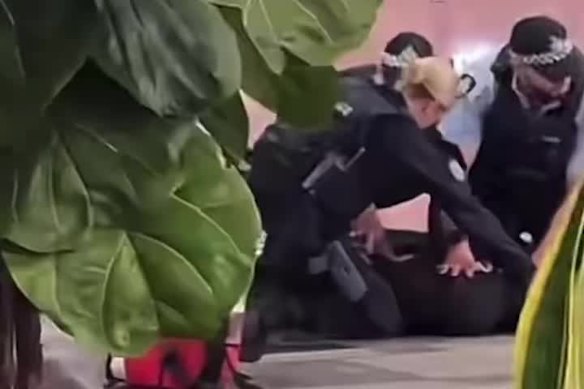 Officers catch the man in Sydney Airport.