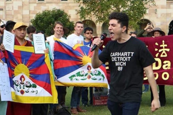 Activist Drew Pavlou speaks at a protest at UQ.