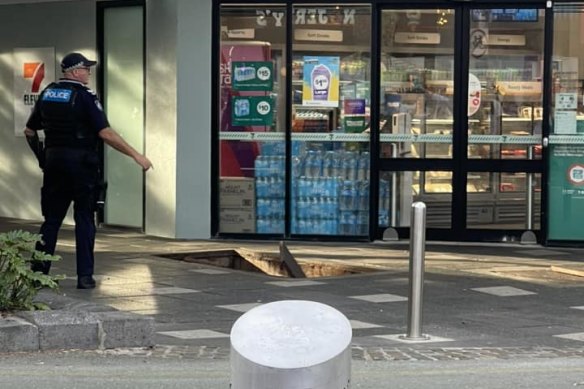 A police officer at the scene of the explosion outside the 7-Eleven store in Surfers Paradise.