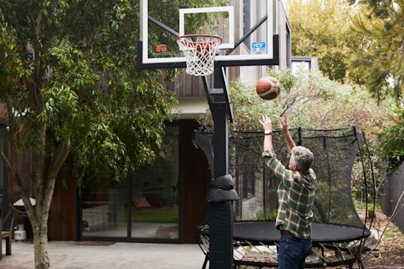 The family love to shoot hoops on the mini court in their backyard. 