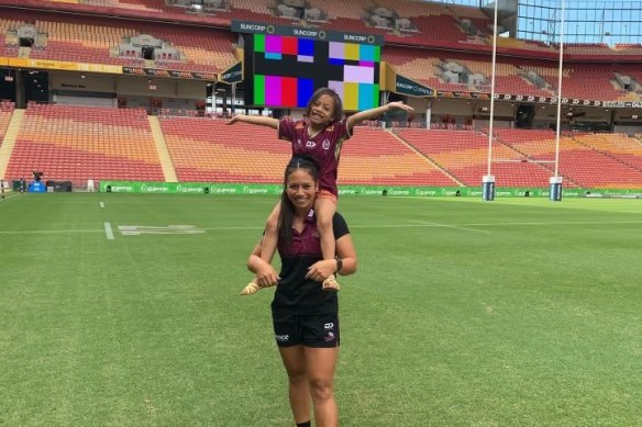 Smith and her daughter, Ruby, at Suncorp Stadium. “The whole team embraces her,” Smith says.
