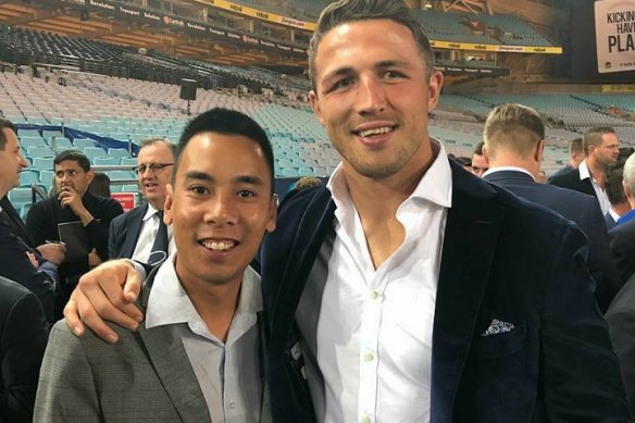 Steven Nguyen (left), a high-ranking tennis official, piled frauds on frauds including pressuring a teaching colleague to lie to a court about a phoney document. He is pictured at an ANZ stadium dinner with Sam Burgess, who is not accused of wrongdoing.