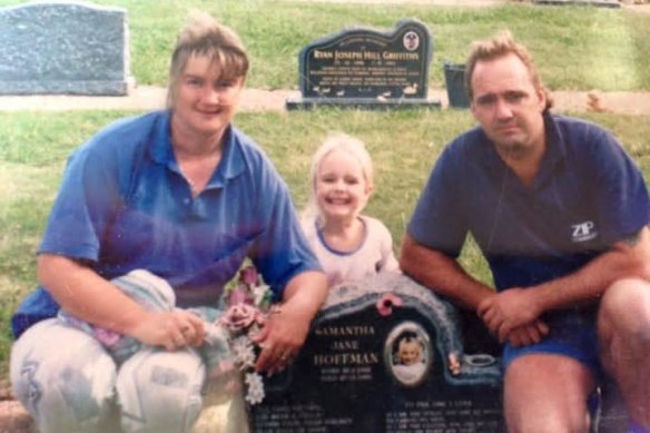 Carolyn and Peter Hoffman with their daughter Lauren at the grave of their late daughter.