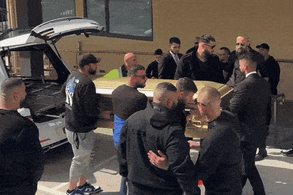 Six men carried a golden casket into the funeral for Sam Abdulrahim.