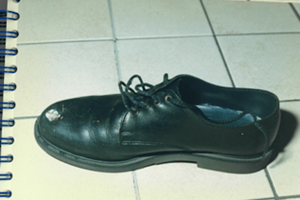 When the gunman shot one guard, the bullet ricocheted into the other's foot; Here, a bullet hole in the guard's shoe is seen as evidence.