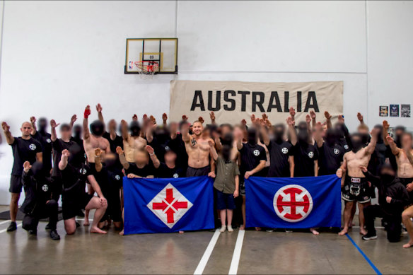 Assembled right-wing activists pose with a child (centre) at Legacy Boxing Gym, in Sunshine West.