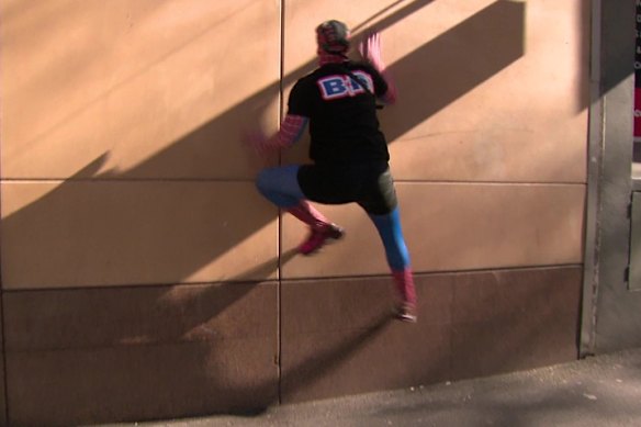 A still from footage of Jack Gibson-Burrell pretending to scale a wall after leaving court.