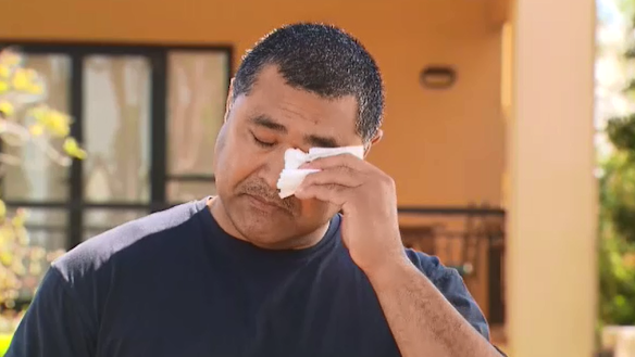 Toutai Kefu wipes away tears outside his Coorparoo home in Brisbane, following his return home from hospital where he was treated for injuries sustained during a violent home invasion.