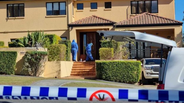 Detectives and forensic officers at the Brisbane home of rugby union player Toutai Kefu on Monday.