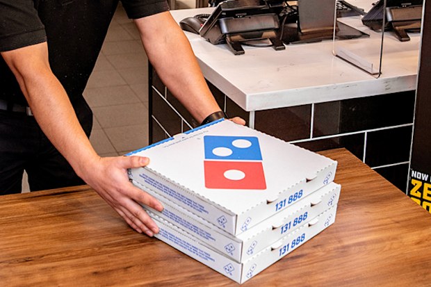 Domino's staff wearing face mask in store, picking up pizza