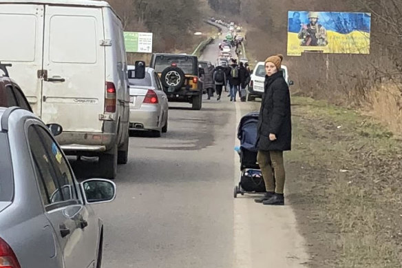 Yuliia Lawriwsky in western Ukraine pushing her son Yaroslav in a pram towards the Polish border.