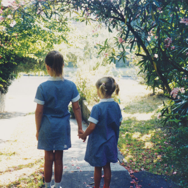 A five-year-old Anna (at right) heading down the driveway for her first day of school, led by her sister, Katie.
