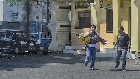 Roni Faisal rescues eight-year-old Ais moments after the attack on Surabaya’s police HQ.