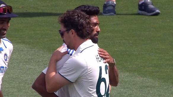 Travis Head and Mohammed Siraj embrace after the Adelaide Test.