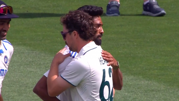 Travis Head and Mohammed Siraj embrace after the Adelaide Test.