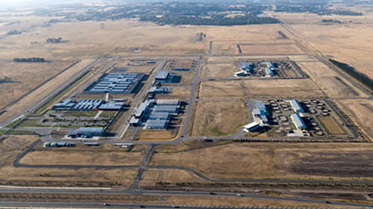 The federal Agriculture Department has voiced concerns that a village-style facility on its land would derail expansion plans.