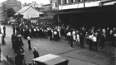 Crowds wait outside McWhirters in Fortitude Valley for free food, date unknown.