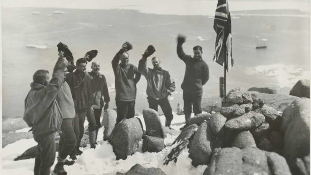 Sir Douglas Mawson and expedition members cheering the raising of the Union Jack flag at Proclamation Harbour, Enderby Land, Antarctica, ca. 1930.