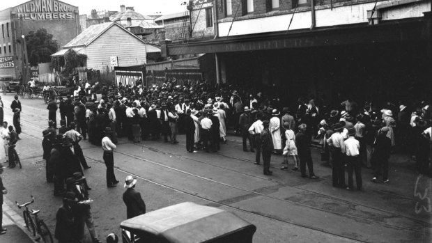Crowds wait outside McWhirters in Fortitude Valley for free food, date unknown.