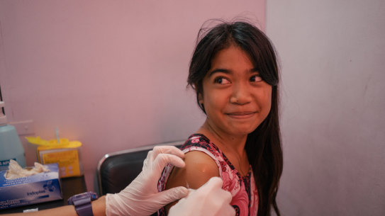 A young girl from Tondo, Manila, is seen in a Likhaan clinic for her free HPV vaccination.